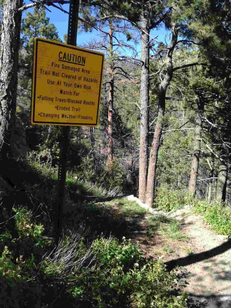 caution sign on a hiking trail accessed from emory pass