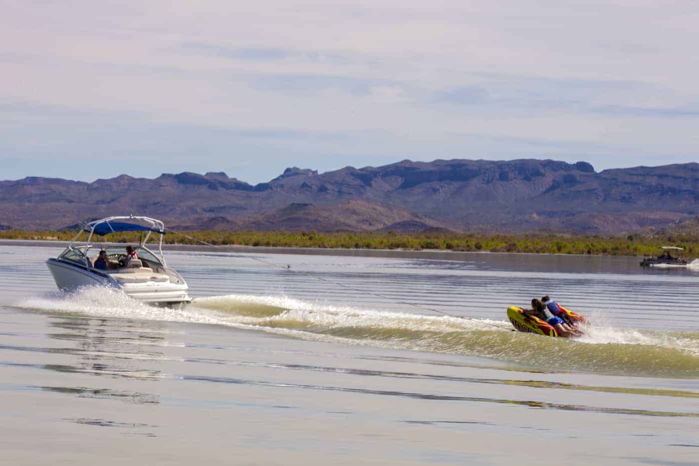 boat towing inflatable tubes at elephant butte lake