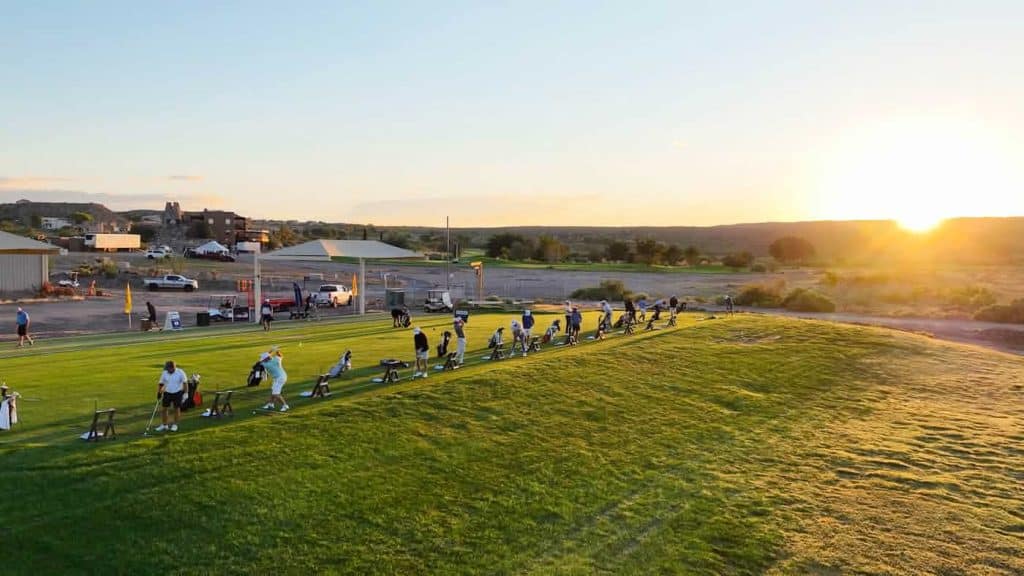 golfers on driving range at new mexico open turtleback mountain golf and resort